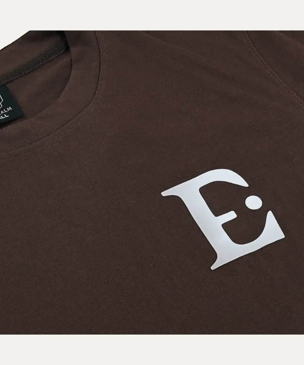 Fallen Angel tee in brown with bold white graphic 'E', showcasing sleek design and relaxed fit for warm weather.
