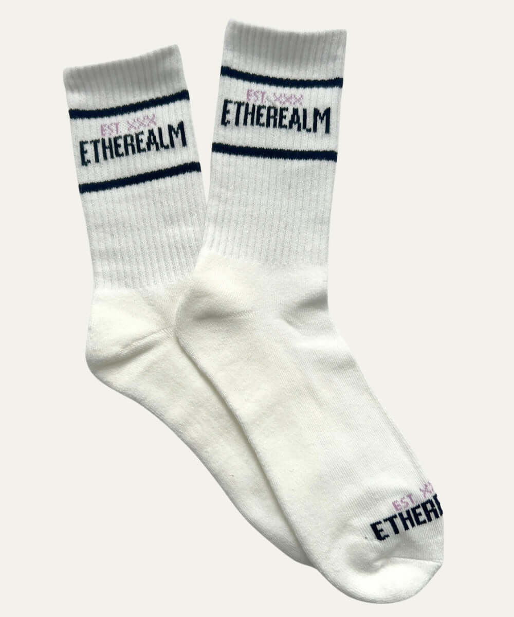 Etherealm striped crew socks in white, featuring bold text design and classic stripe detailing for stylish comfort.