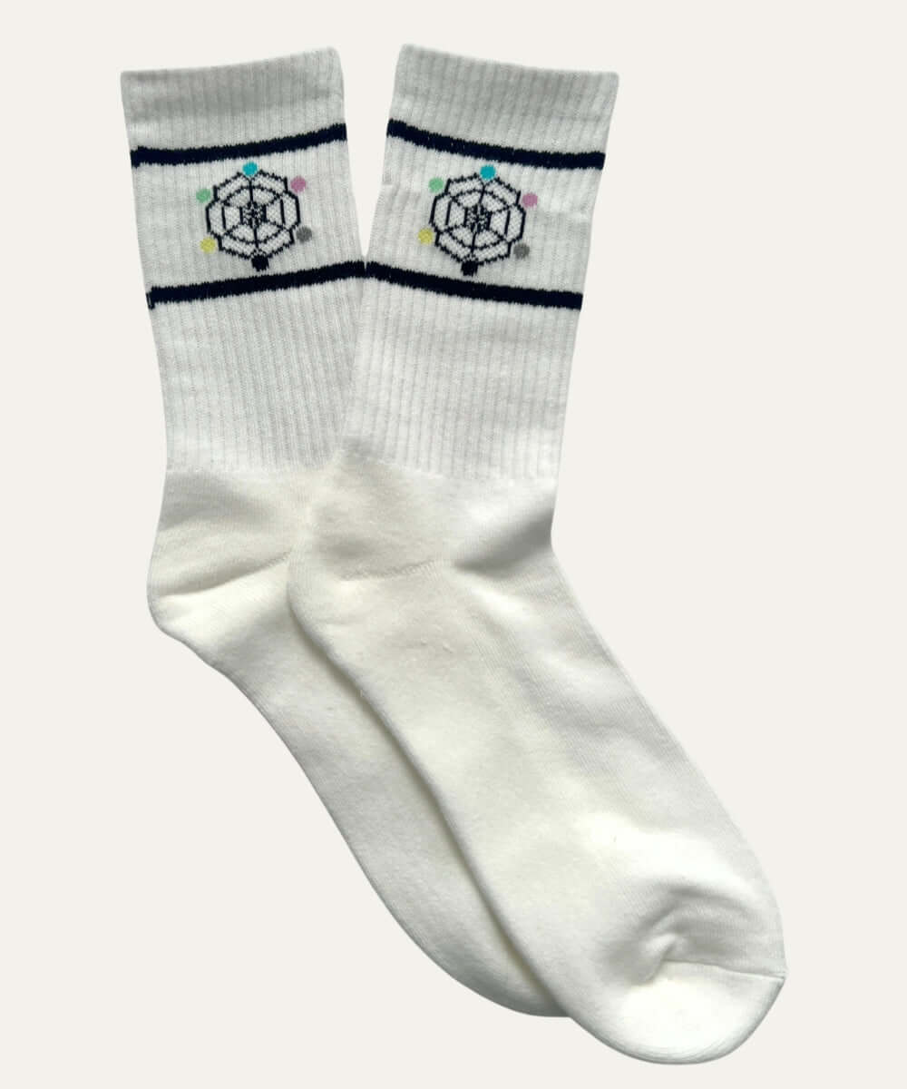 Geometric pattern crew socks in white with bold stripe detailing, combining comfort and style for everyday wear.