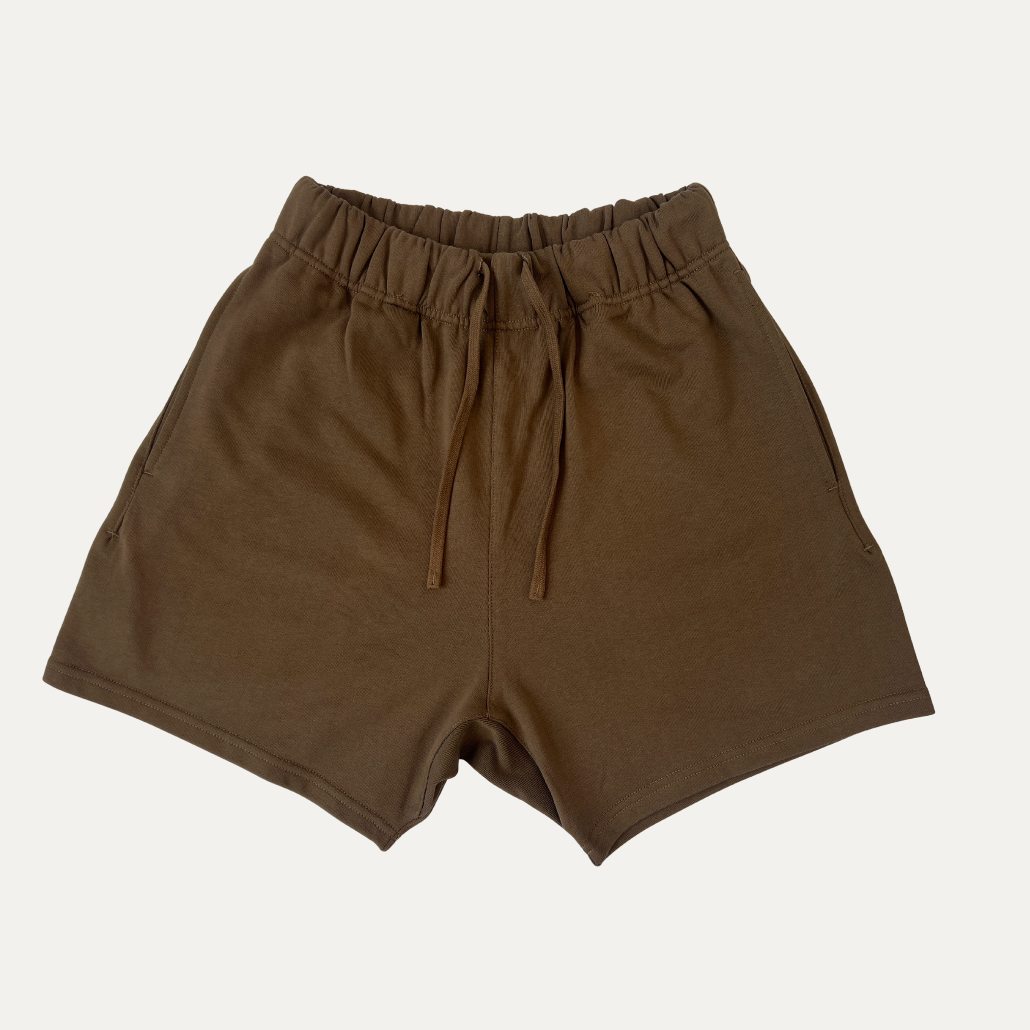 Essential oversized brown shorts made from heavy weight cotton, designed for a relaxed summer fit.